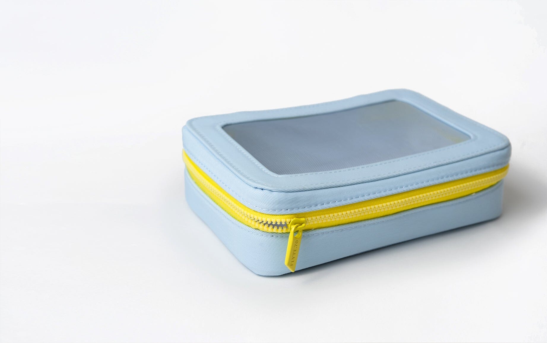 Pale blue vanity case with neon yellow zipper for travel